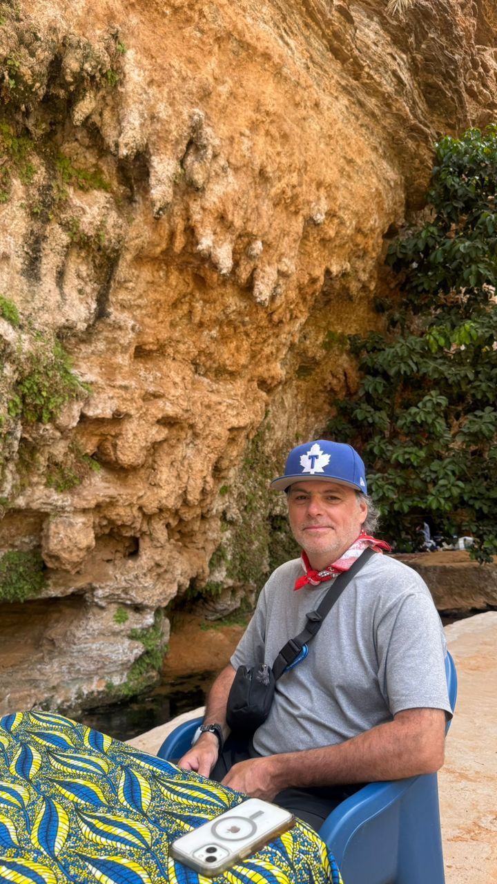 A local guide resting in the shade of Terjit Oasis canyon, Mauritania