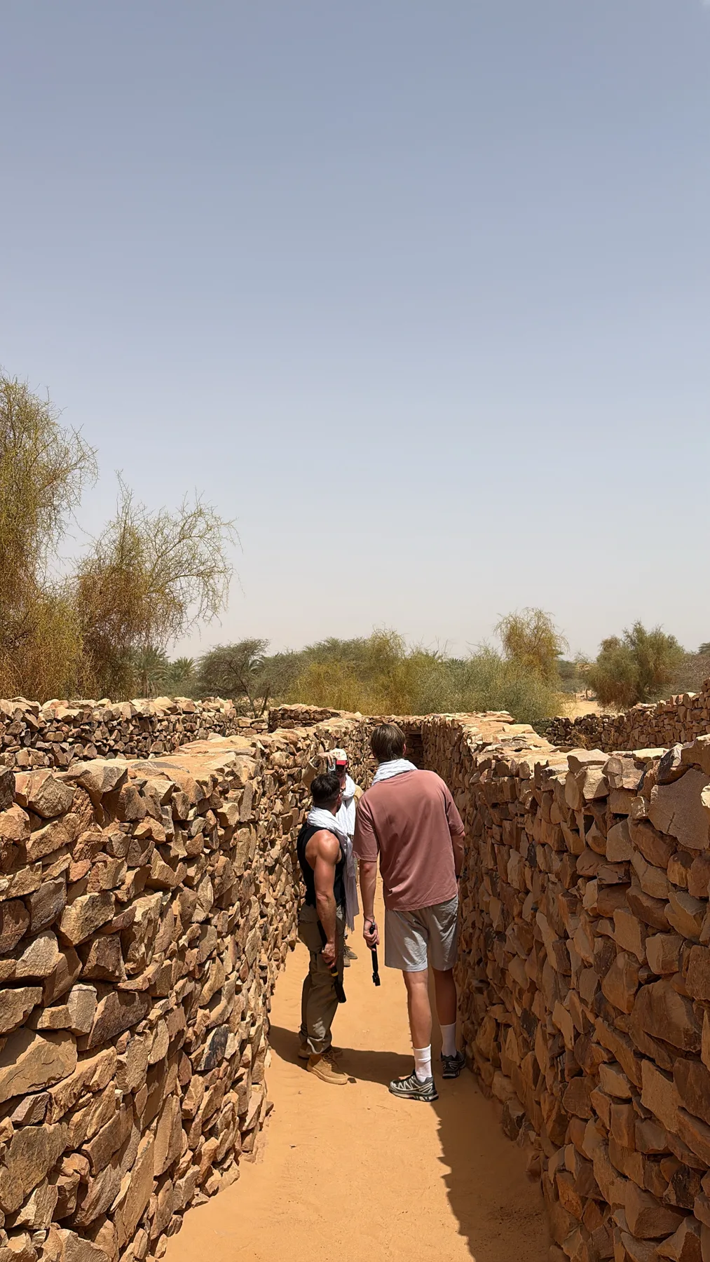 Stone walls of the ancient desert city of Ouadane in Mauritania at sunset